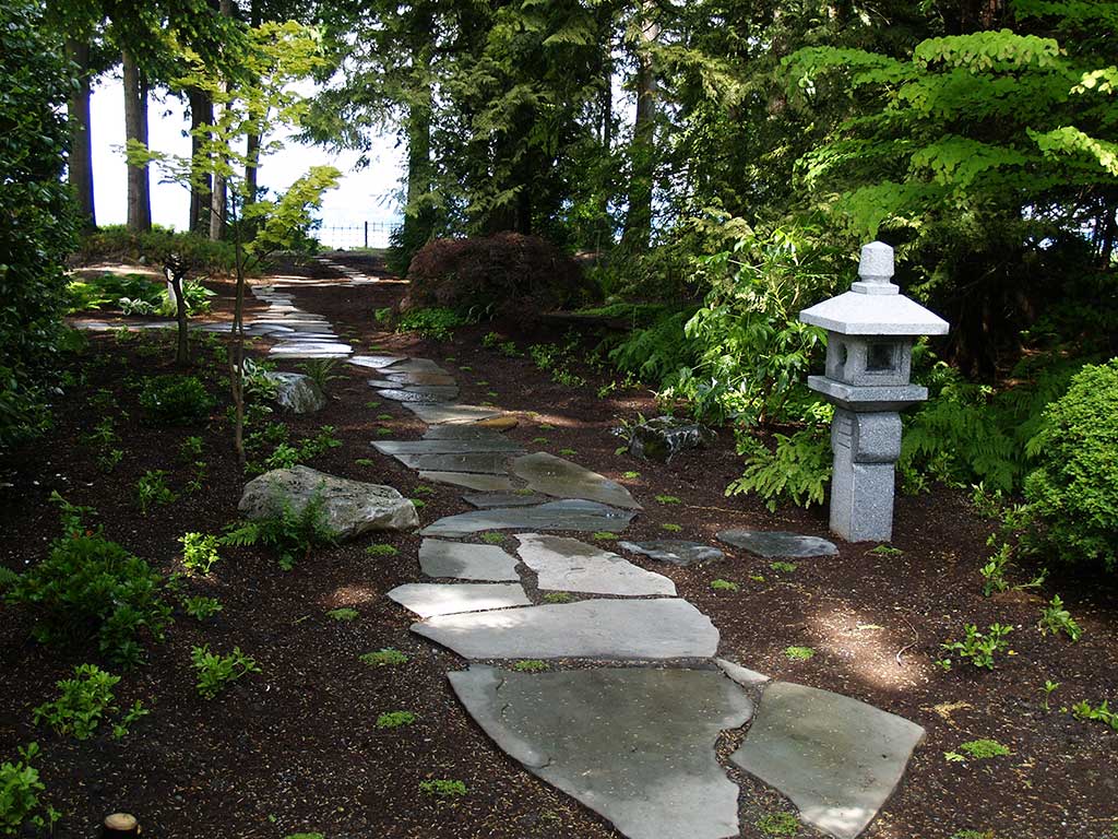 Walkway with Japanese stone lantern .